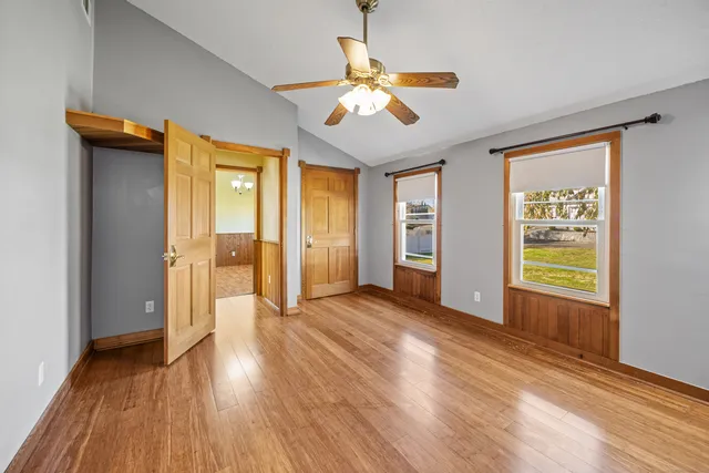a view of a hallway with wooden floor