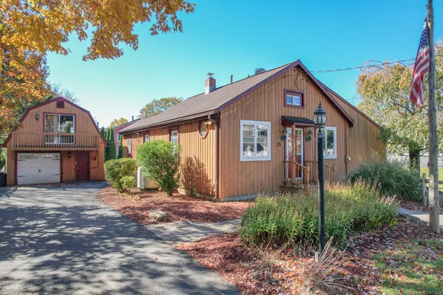 a view of house with yard and glass windows