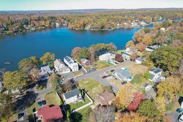 an aerial view of lake and residential houses with outdoor space