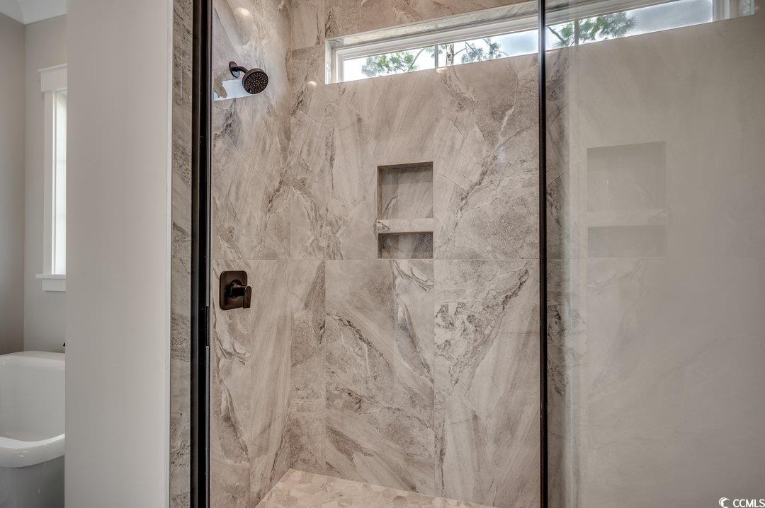404 Plantation Oaks Drive Myrtle Beach, SC 29579 - Photo 11 of 29 Bathroom featuring a marble finish shower