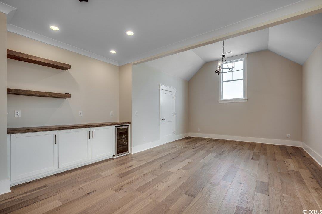 404 Plantation Oaks Drive Myrtle Beach, SC 29579 - Photo 19 of 29 Bonus room featuring beverage cooler, light wood-style floors, baseboards, lofted ceiling, and recessed lighting