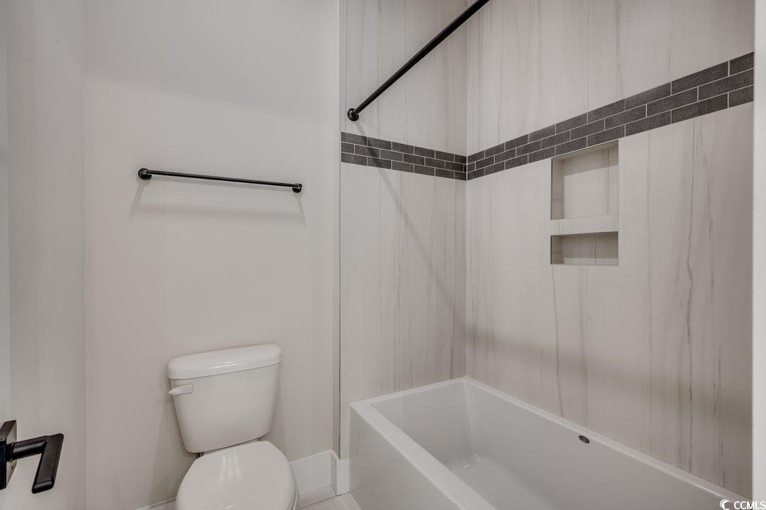 404 Plantation Oaks Drive Myrtle Beach, SC 29579 - Photo 22 of 29 Bathroom featuring toilet, shower / bathtub combination, and baseboards