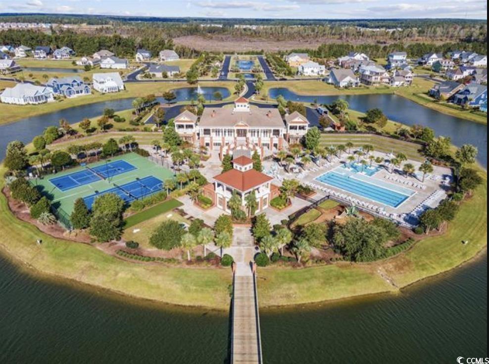 404 Plantation Oaks Drive Myrtle Beach, SC 29579 - Photo 28 of 29 Aerial view of property and surrounding area with a large body of water, a pool area, and nearby suburban area