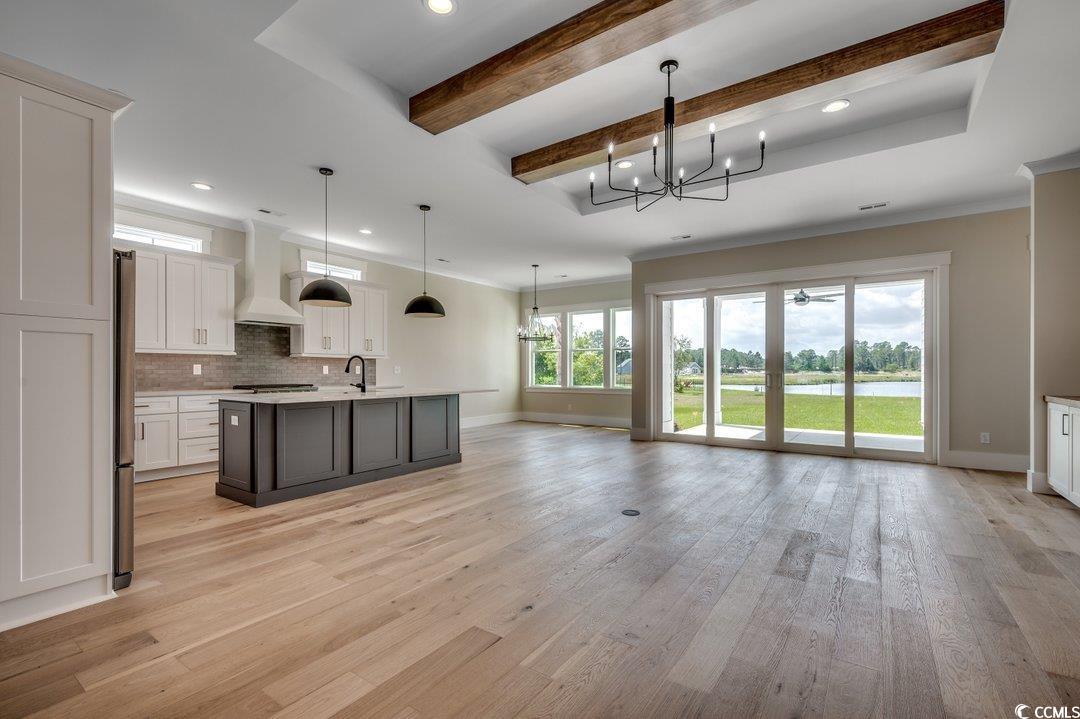 404 Plantation Oaks Drive Myrtle Beach, SC 29579 - Photo 3 of 29 Kitchen with custom range hood, baseboards, a chandelier, recessed lighting, and a sink