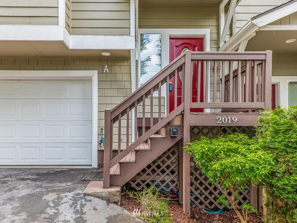 2019 Northeast 9th Court, Unit A Renton, WA 98056 - Photo 2 of 26 a view of a house with wooden fence