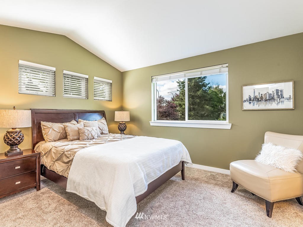 2019 Northeast 9th Court, Unit A Renton, WA 98056 - Photo 12 of 26 a bedroom with a bed and a couch