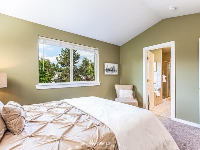 a bedroom with a large bed and a window