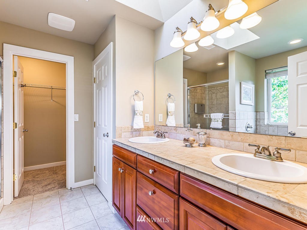 2019 Northeast 9th Court, Unit A Renton, WA 98056 - Photo 14 of 26 a bathroom with a sink double vanity and a mirror