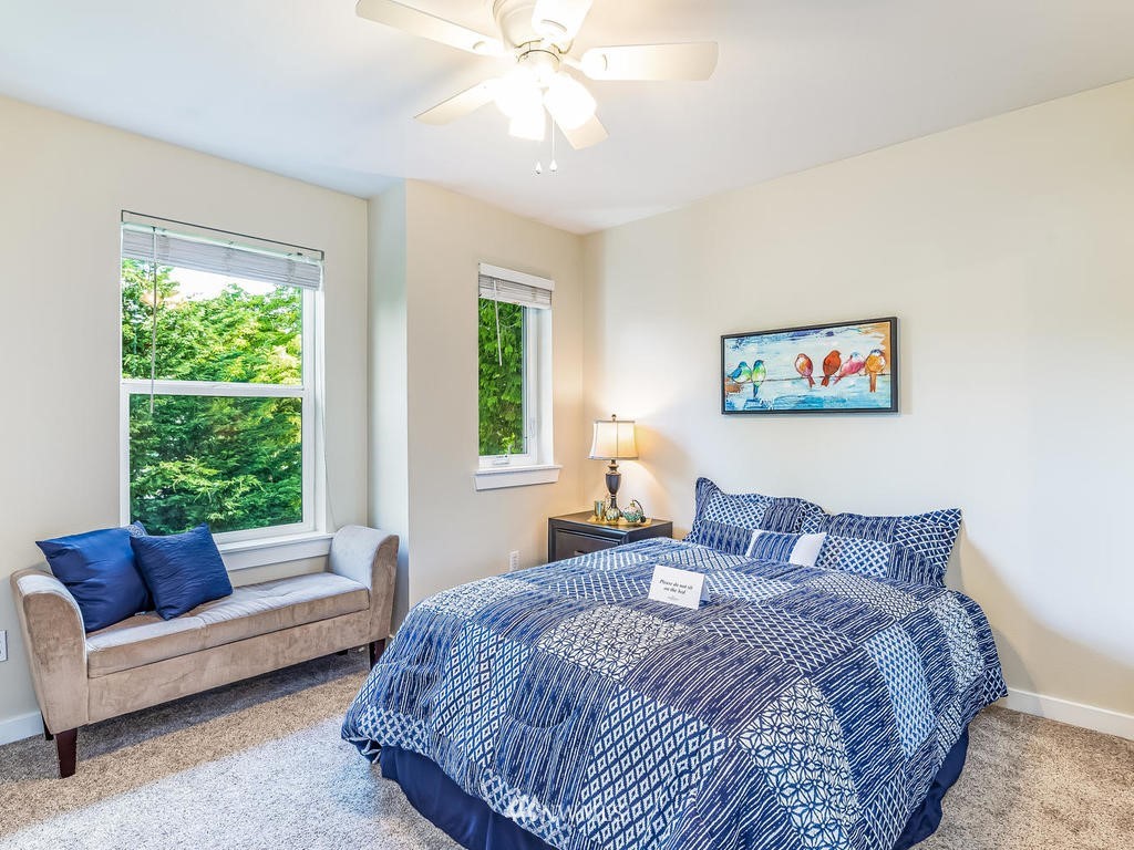 2019 Northeast 9th Court, Unit A Renton, WA 98056 - Photo 16 of 26 a bedroom with a bed a couch and a window