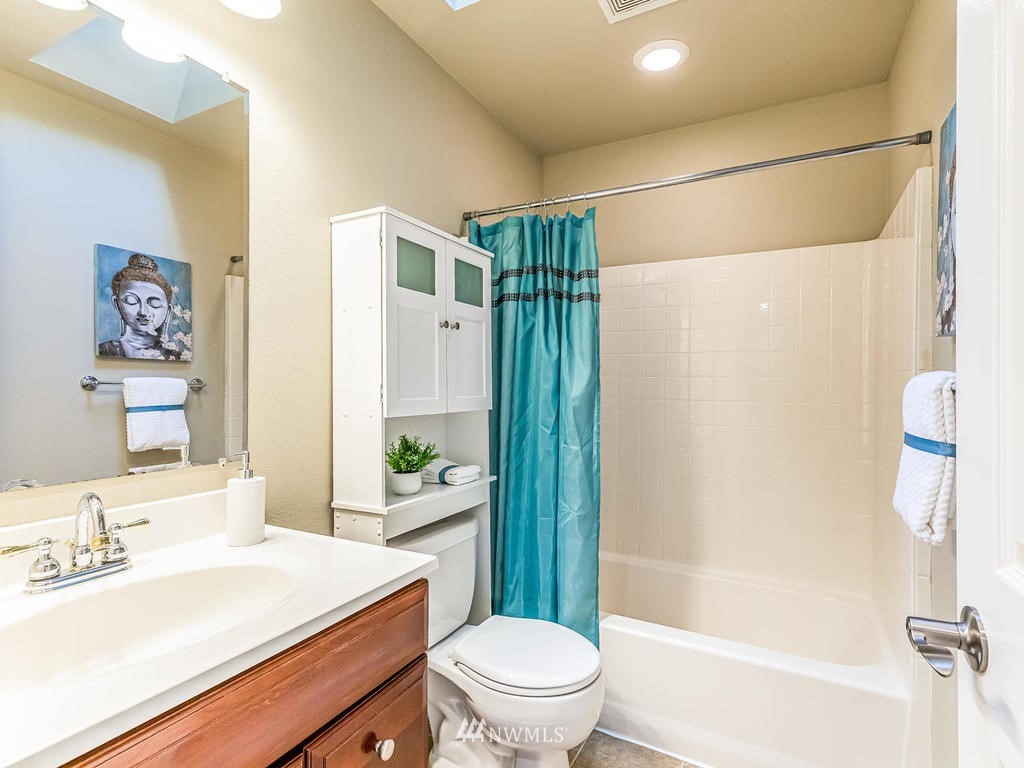 2019 Northeast 9th Court, Unit A Renton, WA 98056 - Photo 17 of 26 a bathroom with a sink a toilet a mirror a vanity and shower