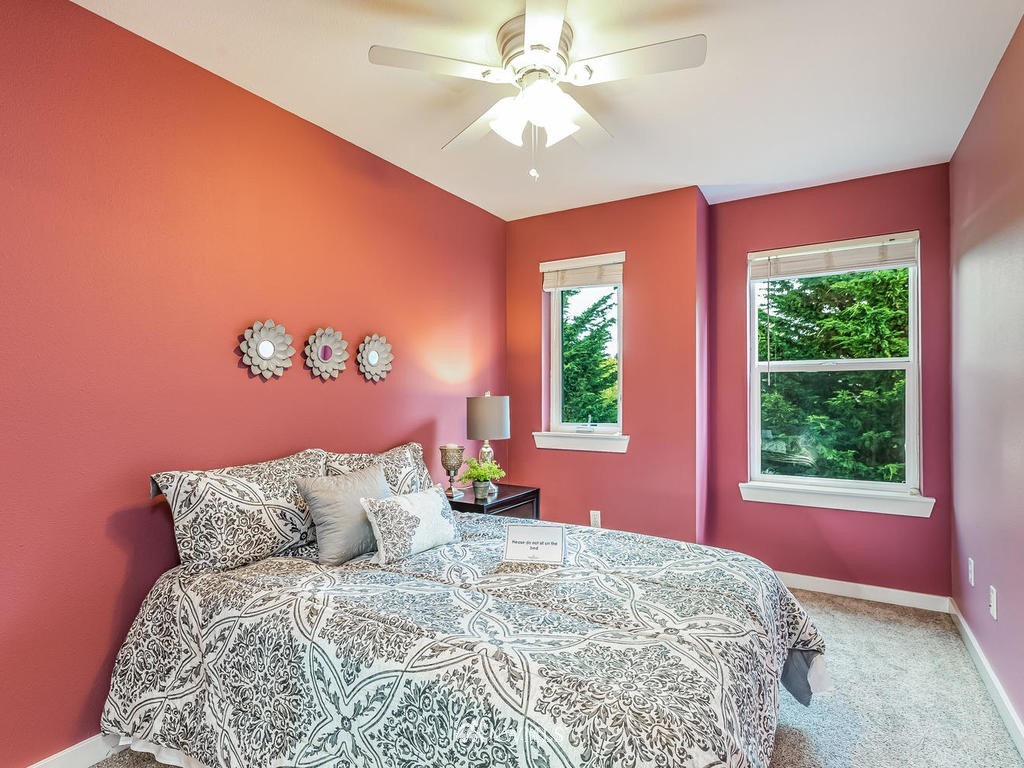 2019 Northeast 9th Court, Unit A Renton, WA 98056 - Photo 18 of 26 a bed sitting in a bedroom next to a window