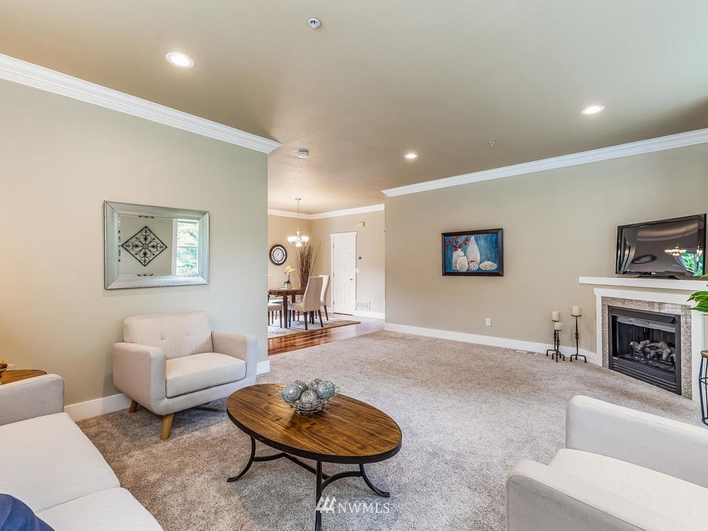 2019 Northeast 9th Court, Unit A Renton, WA 98056 - Photo 5 of 26 a living room with furniture a rug and a fireplace