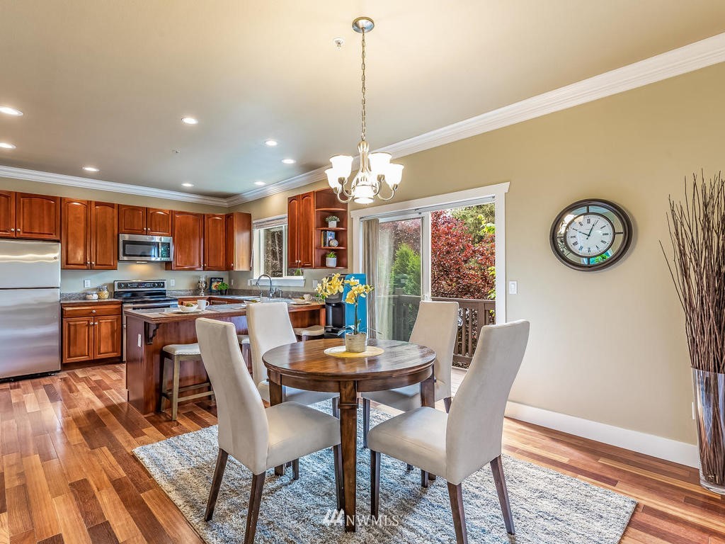 2019 Northeast 9th Court, Unit A Renton, WA 98056 - Photo 8 of 26 a view of a dining room with furniture window and wooden floor