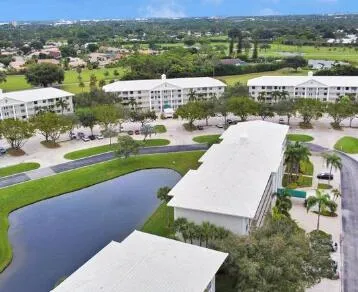 an aerial view of a house with a yard and lake view