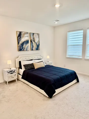 a bedroom with a bed and a couch