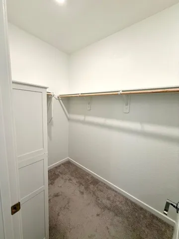 an empty room with chair and white walls