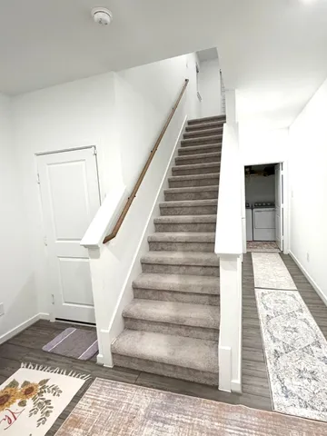 a view of entryway and hall with wooden floor