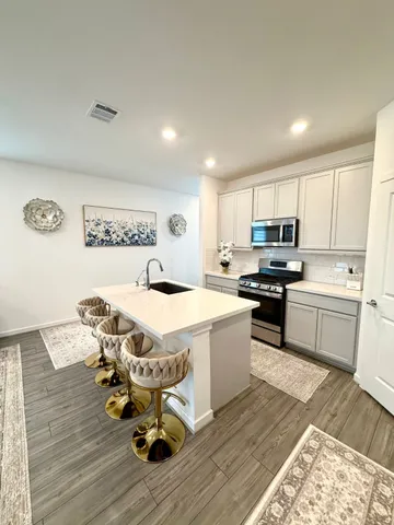 a kitchen with a sink appliances and cabinets