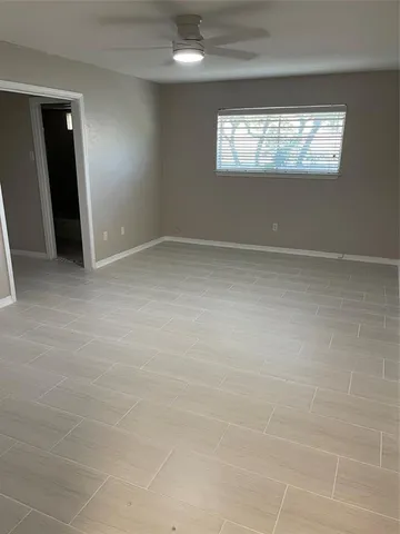 en empty room with windows and entrance