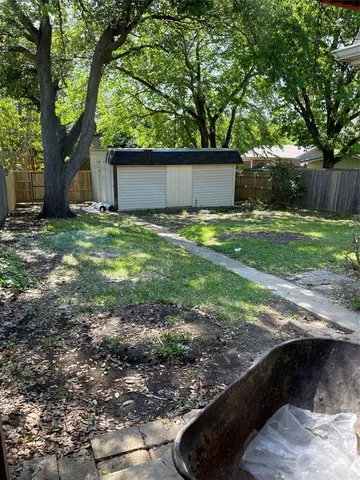 a view of a backyard with large trees