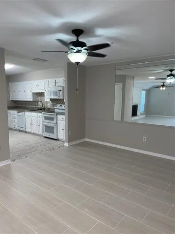 a view of a kitchen with a sink and stainless steel appliances