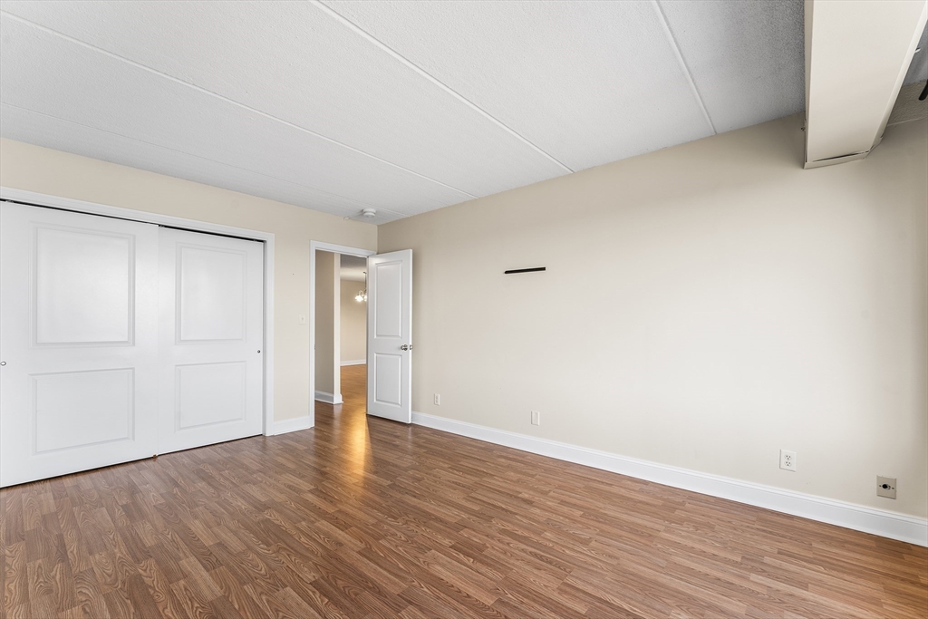 1500 Worcester Road, Unit 830 Framingham, MA 01702 - Photo 12 of 23 a view of an empty room with wooden floor