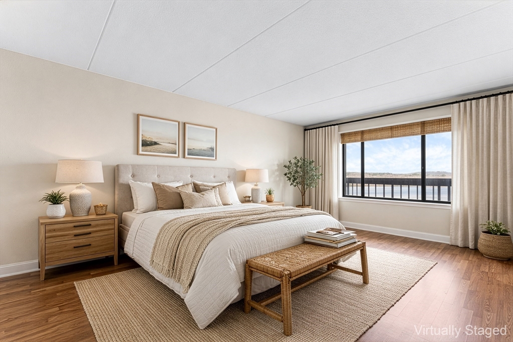 1500 Worcester Road, Unit 830 Framingham, MA 01702 - Photo 13 of 23 a bedroom with a bed and a large window