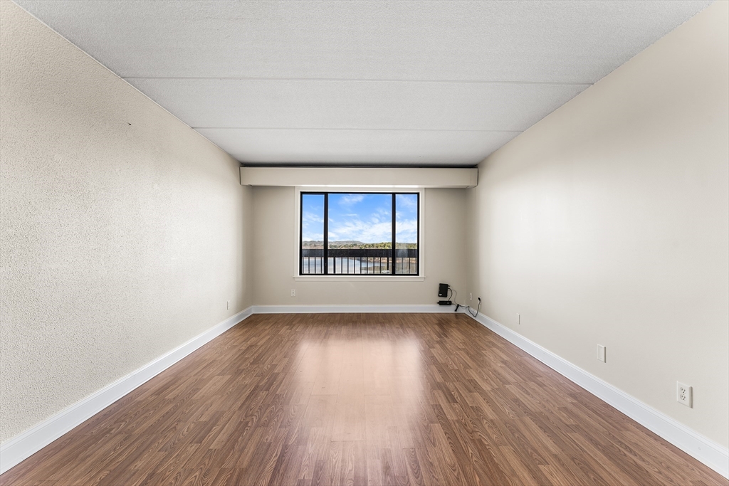 1500 Worcester Road, Unit 830 Framingham, MA 01702 - Photo 15 of 23 an empty room with wooden floor and windows
