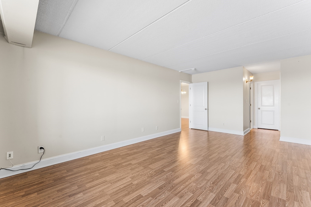 1500 Worcester Road, Unit 830 Framingham, MA 01702 - Photo 16 of 23 a view of an empty room and wooden floor