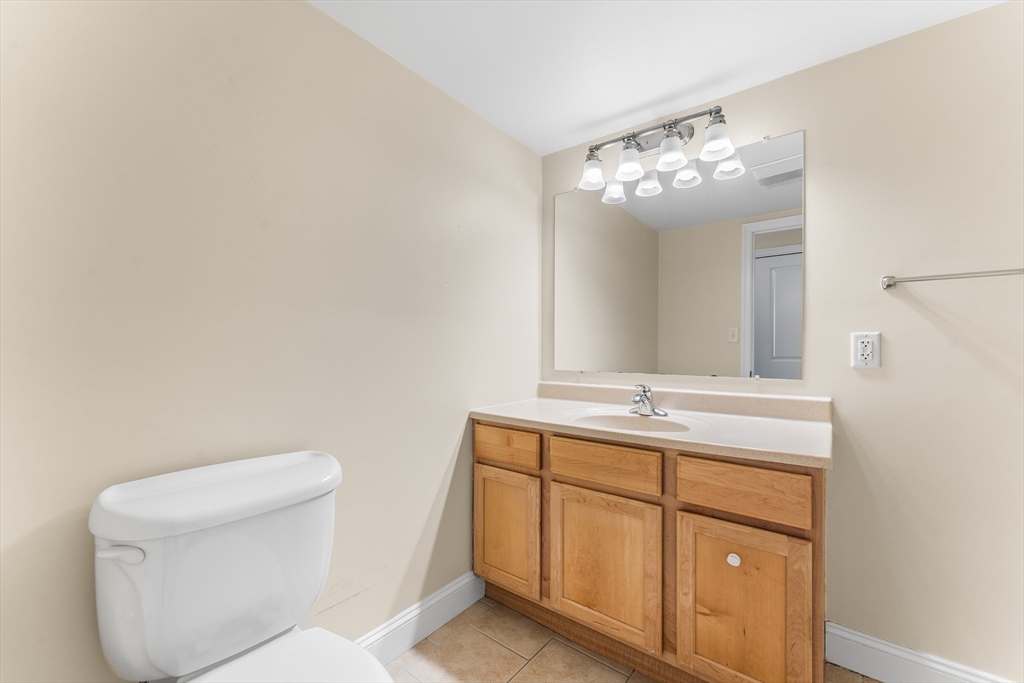 1500 Worcester Road, Unit 830 Framingham, MA 01702 - Photo 17 of 23 a bathroom with a toilet sink and mirror
