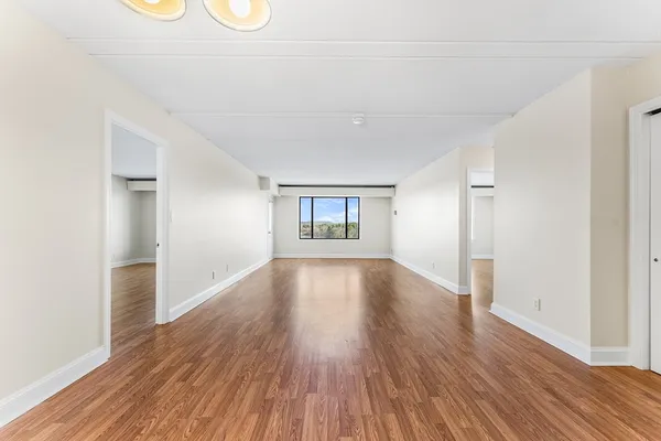 wooden floor in an empty room with a window