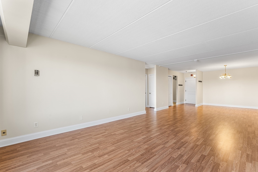 1500 Worcester Road, Unit 830 Framingham, MA 01702 - Photo 5 of 23 a view of an empty room and wooden floor