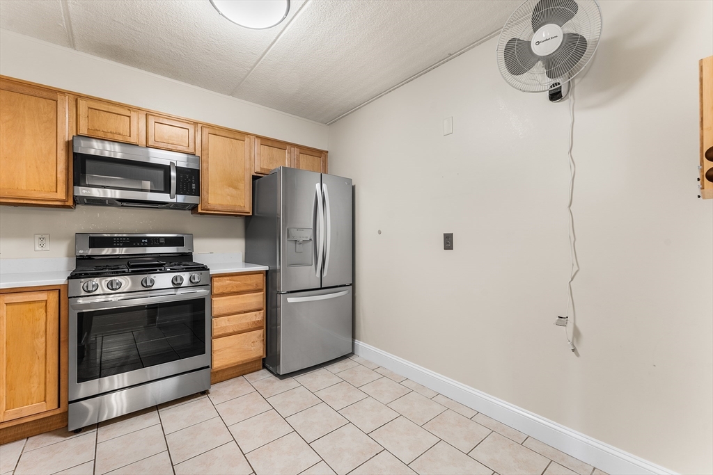 1500 Worcester Road, Unit 830 Framingham, MA 01702 - Photo 7 of 23 a kitchen with stainless steel appliances a stove microwave and refrigerator