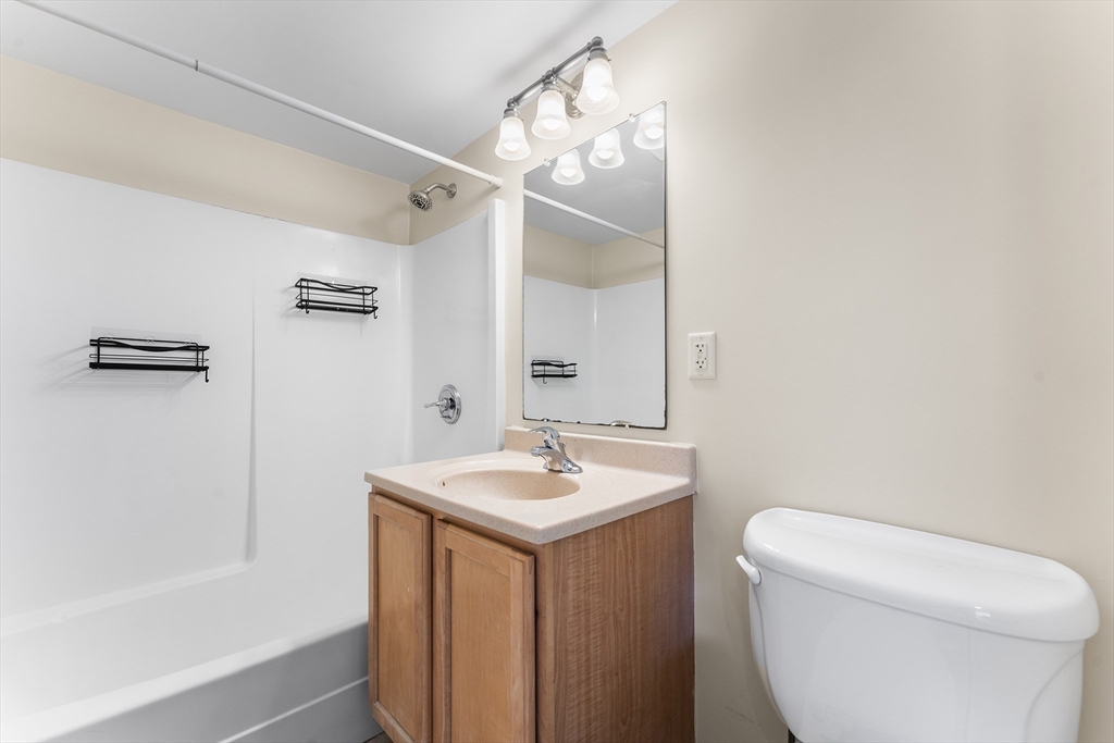 1500 Worcester Road, Unit 830 Framingham, MA 01702 - Photo 9 of 23 a bathroom with a sink a toilet and shower