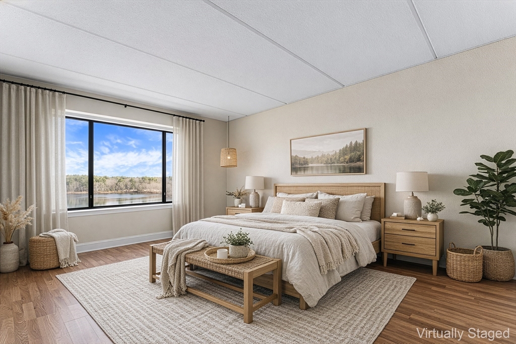 1500 Worcester Road, Unit 830 Framingham, MA 01702 - Photo 10 of 23 a bedroom with a bed and a large window