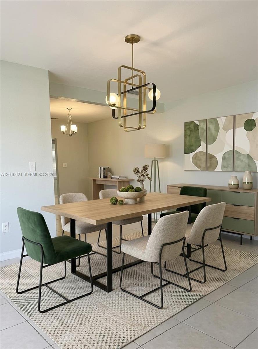 2412 Southwest 11th Street, Unit 1 Miami, FL 33135 - Photo 3 of 12 a view of a dining room with furniture and chandelier