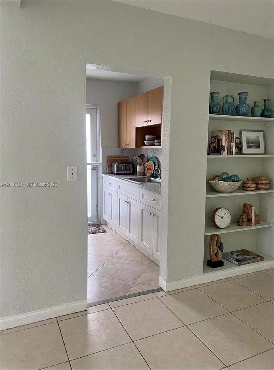 2412 Southwest 11th Street, Unit 1 Miami, FL 33135 - Photo 5 of 12 a kitchen with granite countertop a cabinets and a stove top oven