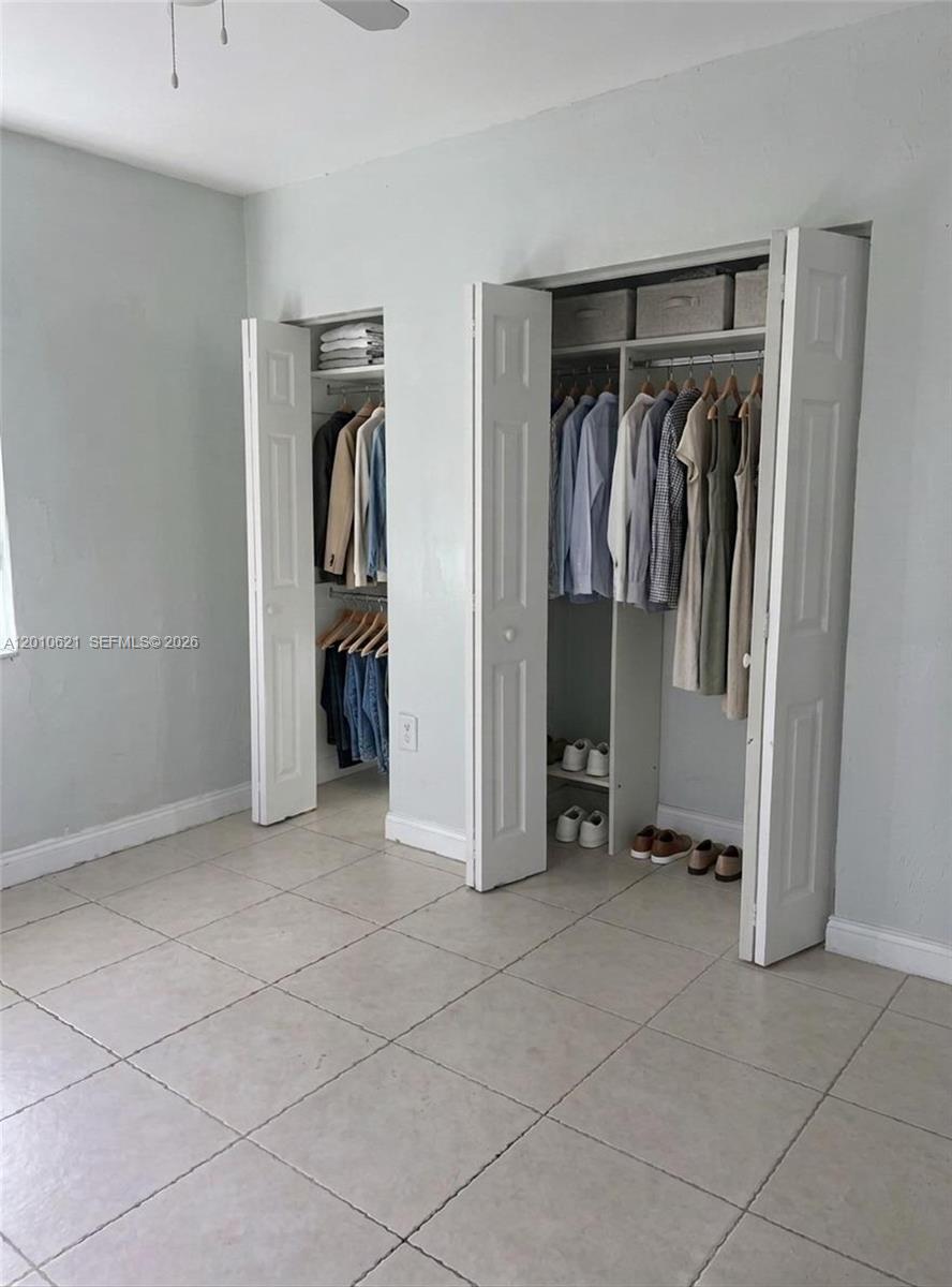 2412 Southwest 11th Street, Unit 1 Miami, FL 33135 - Photo 8 of 12 a view of walk in closet with clothes and shoes