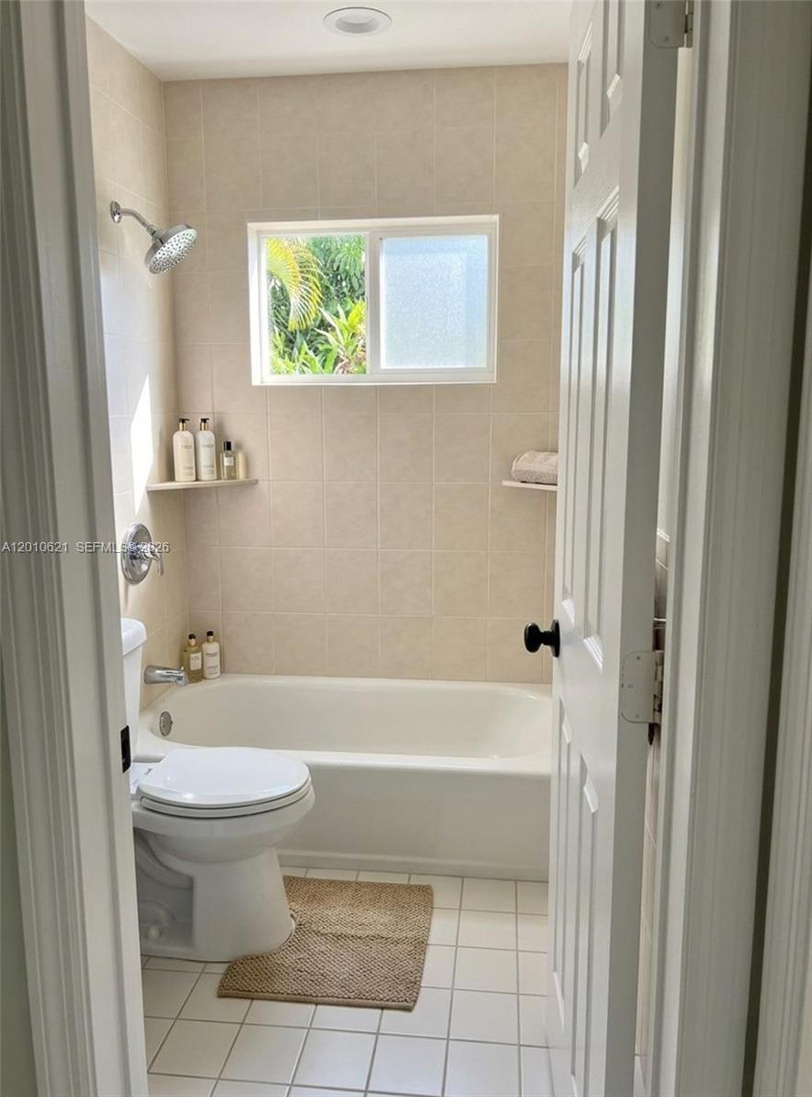 2412 Southwest 11th Street, Unit 1 Miami, FL 33135 - Photo 9 of 12 a bathroom with a toilet and a bathtub