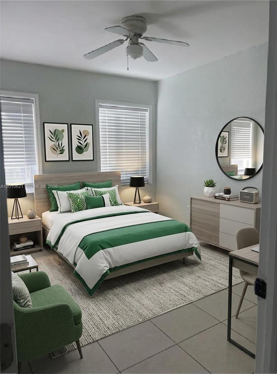 2412 Southwest 11th Street, Unit 1 Miami, FL 33135 - Photo 10 of 12 a bedroom with a bed and a chandelier