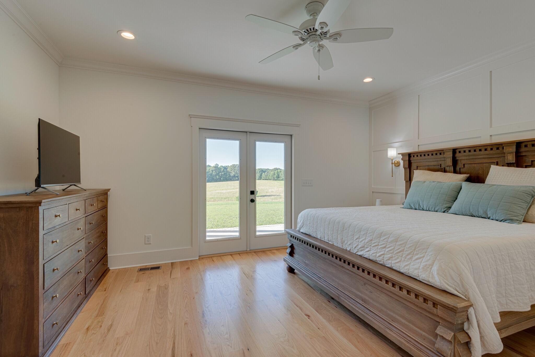 1386 Eno Road Dickson, TN 37055 - Photo 28 of 59 a spacious bedroom with a bed and a flat screen tv