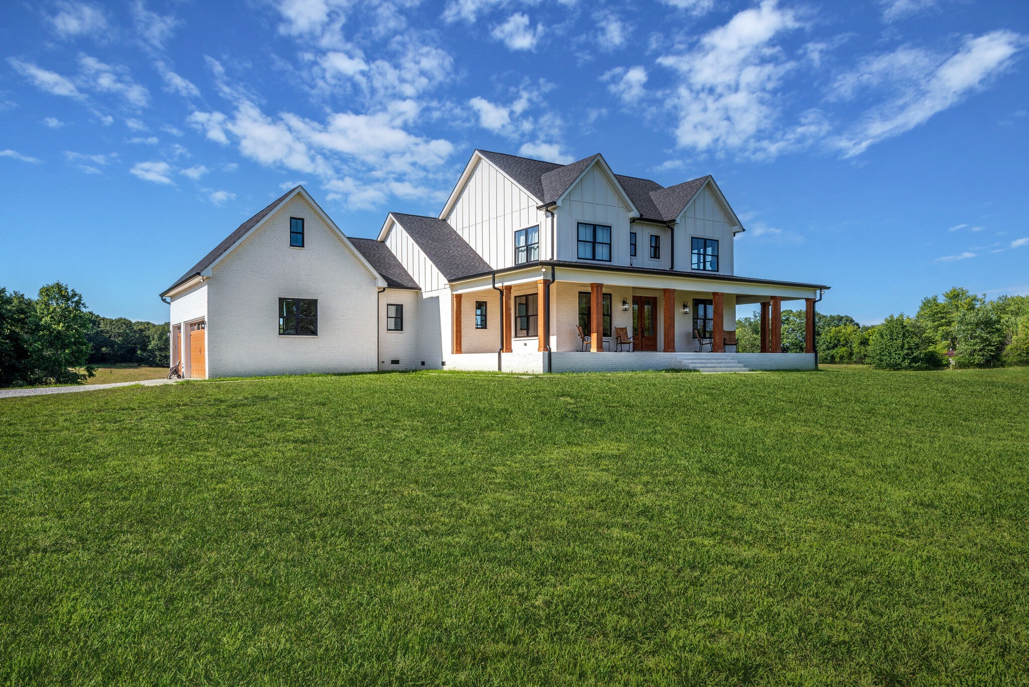 1386 Eno Road Dickson, TN 37055 - Photo 40 of 59 a front view of a house with a garden and plants