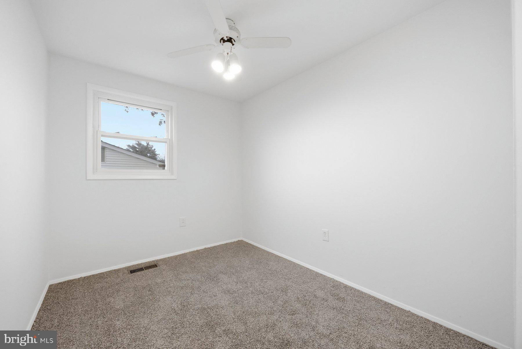 341 Dameron Street South Laurel, MD 20724 - Photo 18 of 32 an empty room with a ceiling fan and window