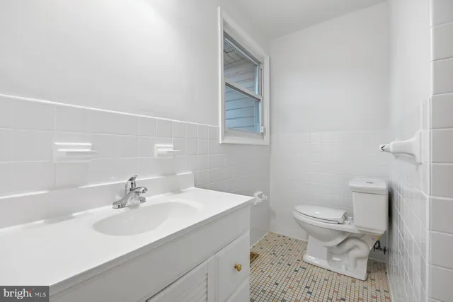 a bathroom with a sink toilet and a mirror