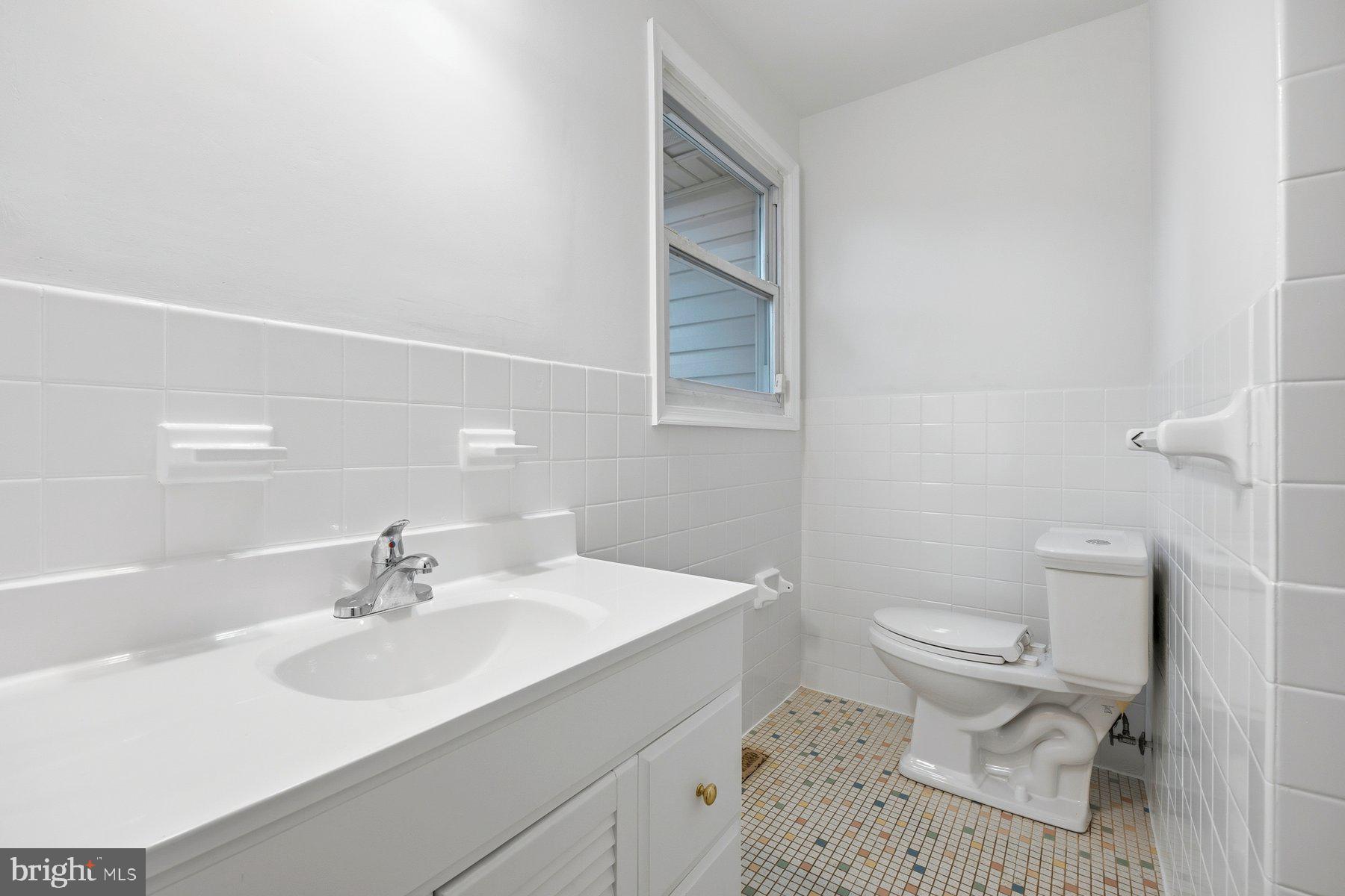 341 Dameron Street South Laurel, MD 20724 - Photo 19 of 32 a bathroom with a sink toilet and a mirror