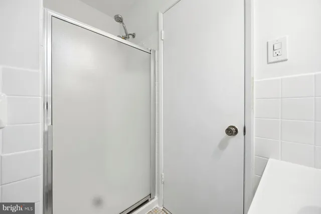 a bathroom with a shower and a mirror