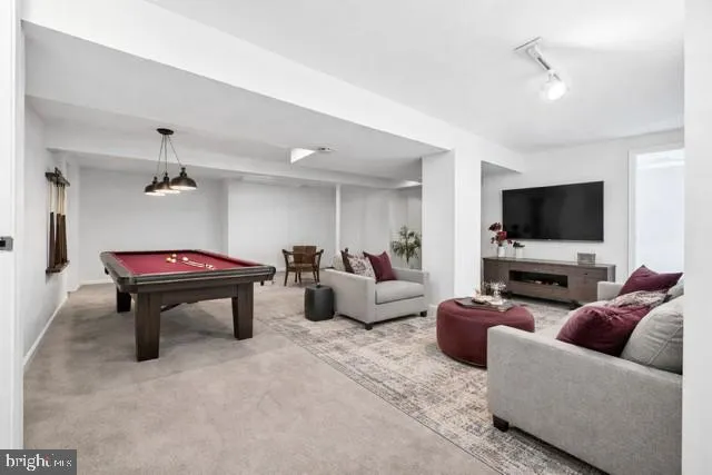a view of an empty room with closet and a window