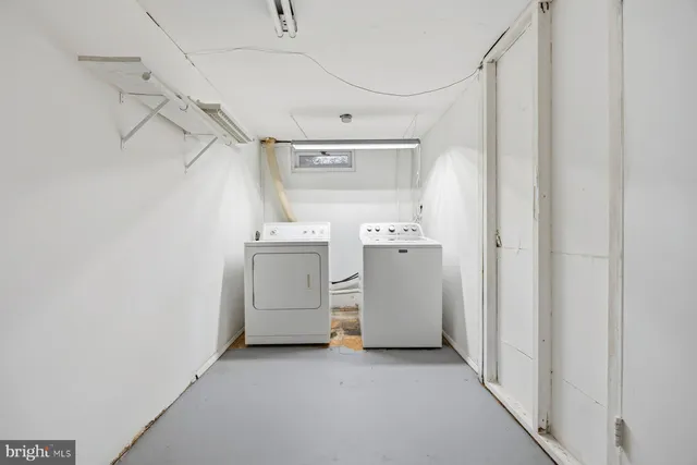 a view of water heater room with refrigerator