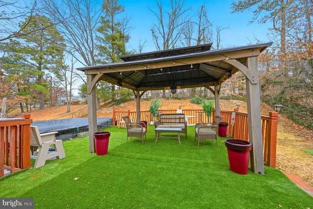 a backyard of a house with barbeque oven table and chairs