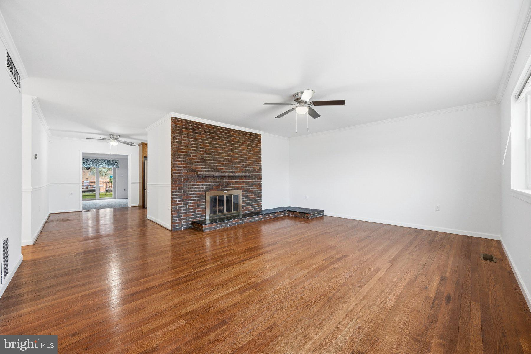 341 Dameron Street South Laurel, MD 20724 - Photo 3 of 32 wooden floor in an empty room with a fireplace